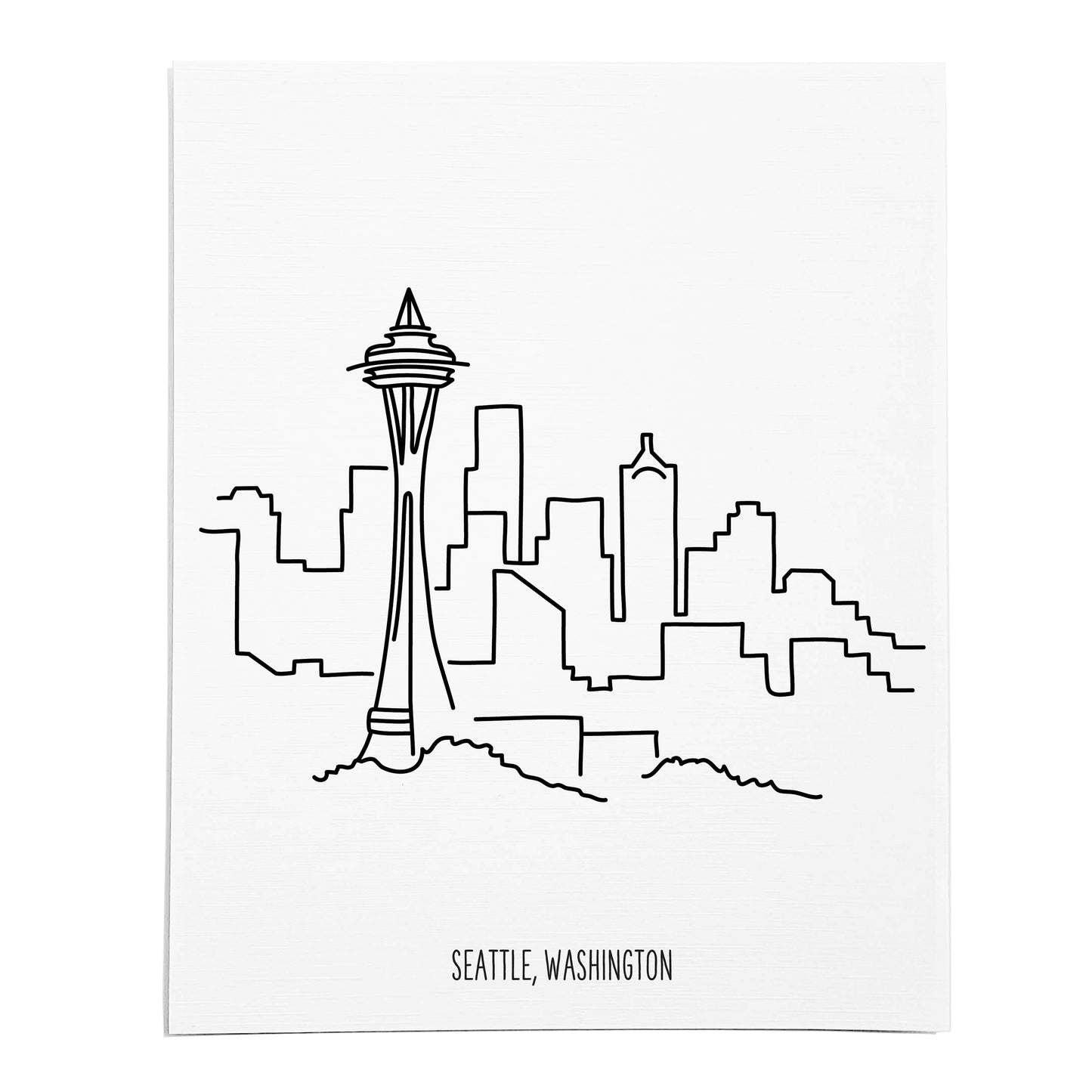 An art print featuring a line drawing of the Seattle Skyline on white linen paper