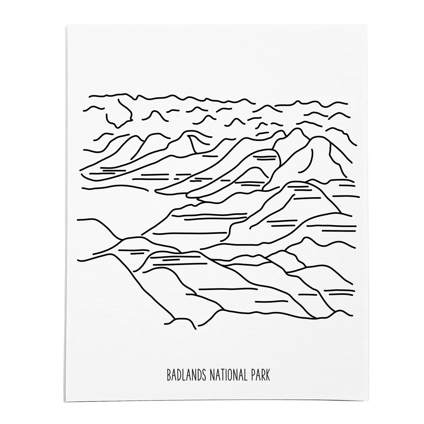 An art print featuring a line drawing of Badlands National Park on white linen paper