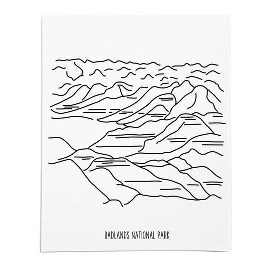 An art print featuring a line drawing of Badlands National Park on white linen paper