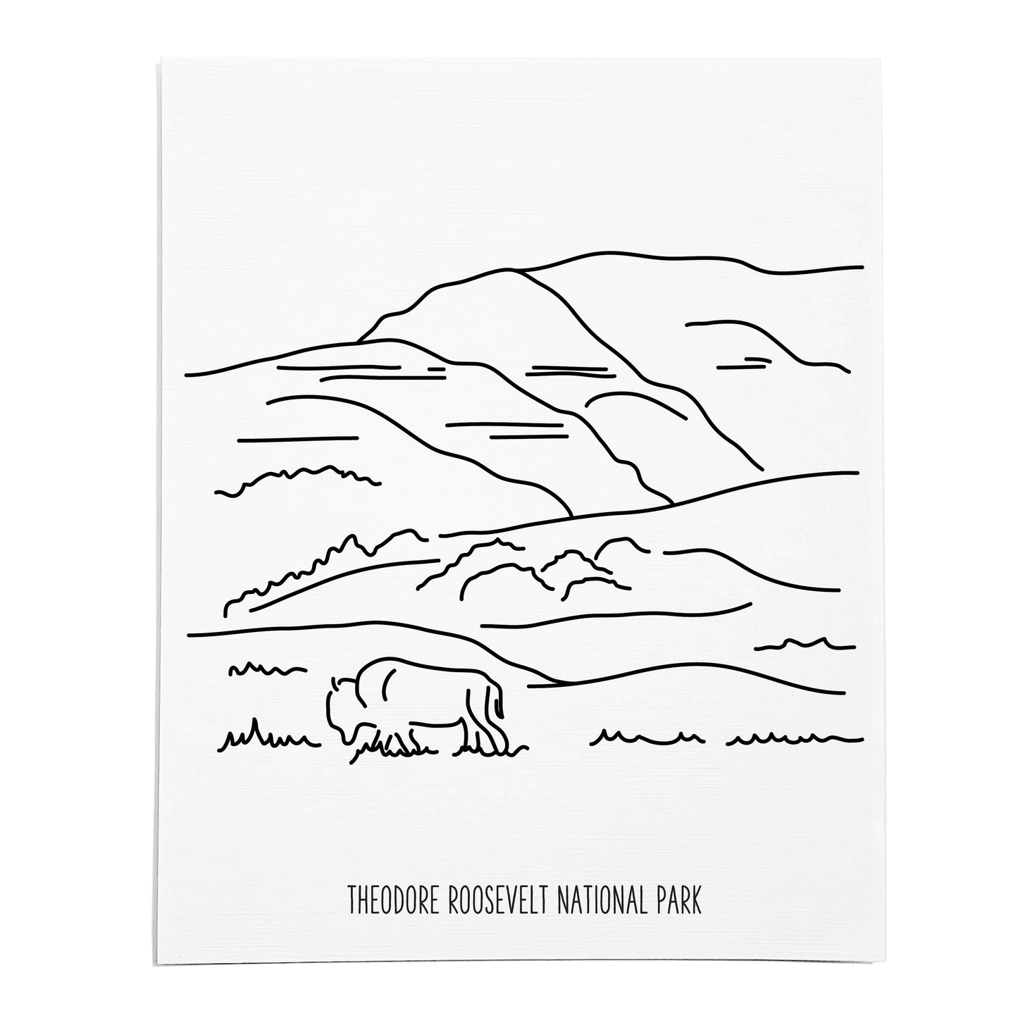 An art print featuring a line drawing of Theodore Roosevelt National Park on white linen paper
