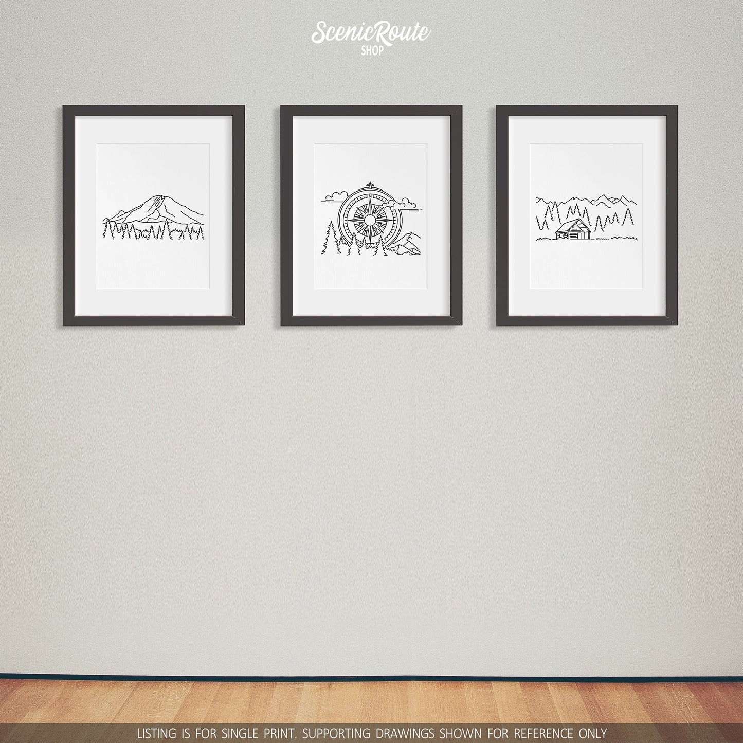 A group of three framed drawings on a white wall. The line art drawings include Mount Rainier National Park, the Adventure Compass Drawing, and a Cabin