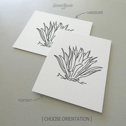 Two line art drawings of an Agave Cactus on white linen paper with a gray background.  The pieces are shown in portrait and landscape orientation for the available art print options.