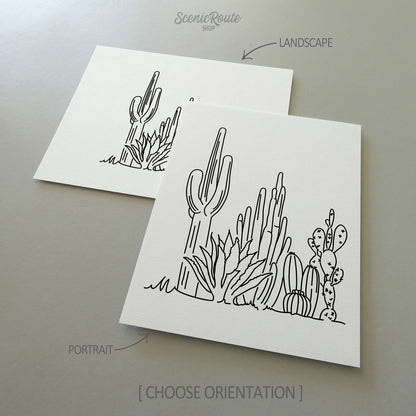 Two line art drawings of a Cactus Garden on white linen paper with a gray background.  The pieces are shown in portrait and landscape orientation for the available art print options.