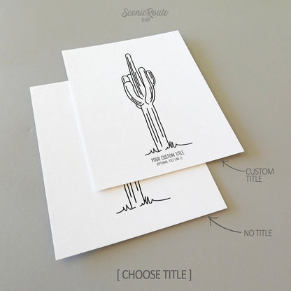 Two line art drawings of a Saguaro Cactus on white linen paper with a gray background.  The pieces are shown with “No Title” and “Custom Title” options for the available art print options.