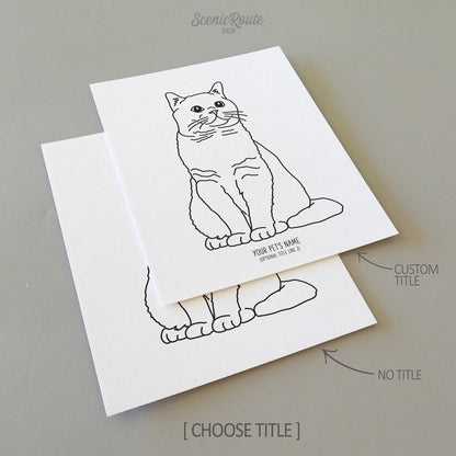 Two line art drawings of a British Shorthair Cat on white linen paper with a gray background.  The pieces are shown with “No Title” and “Custom Title” options for the available art print options.