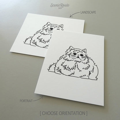 Two line art drawings of a Himalayan cat on white linen paper with a gray background.  The pieces are shown in portrait and landscape orientation for the available art print options.