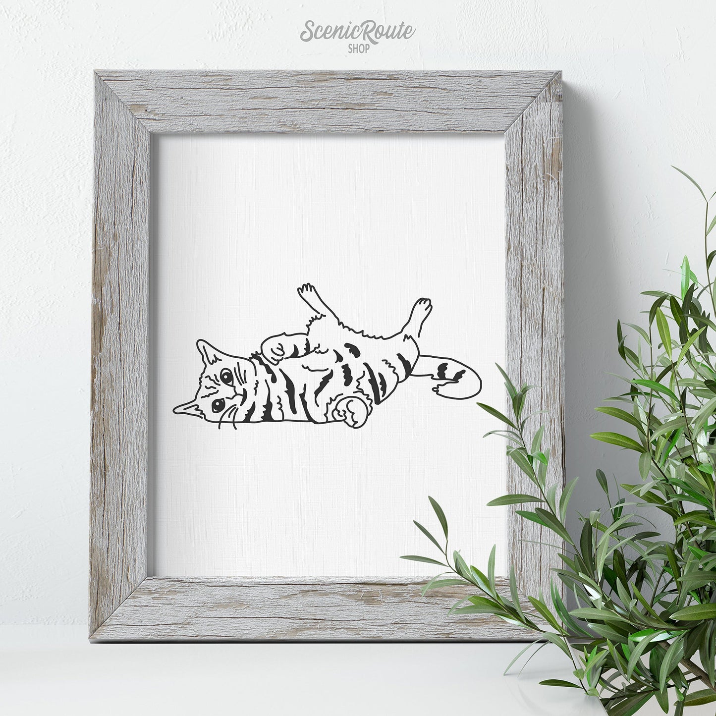 A framed line art drawing of a Playful Cat with a plant