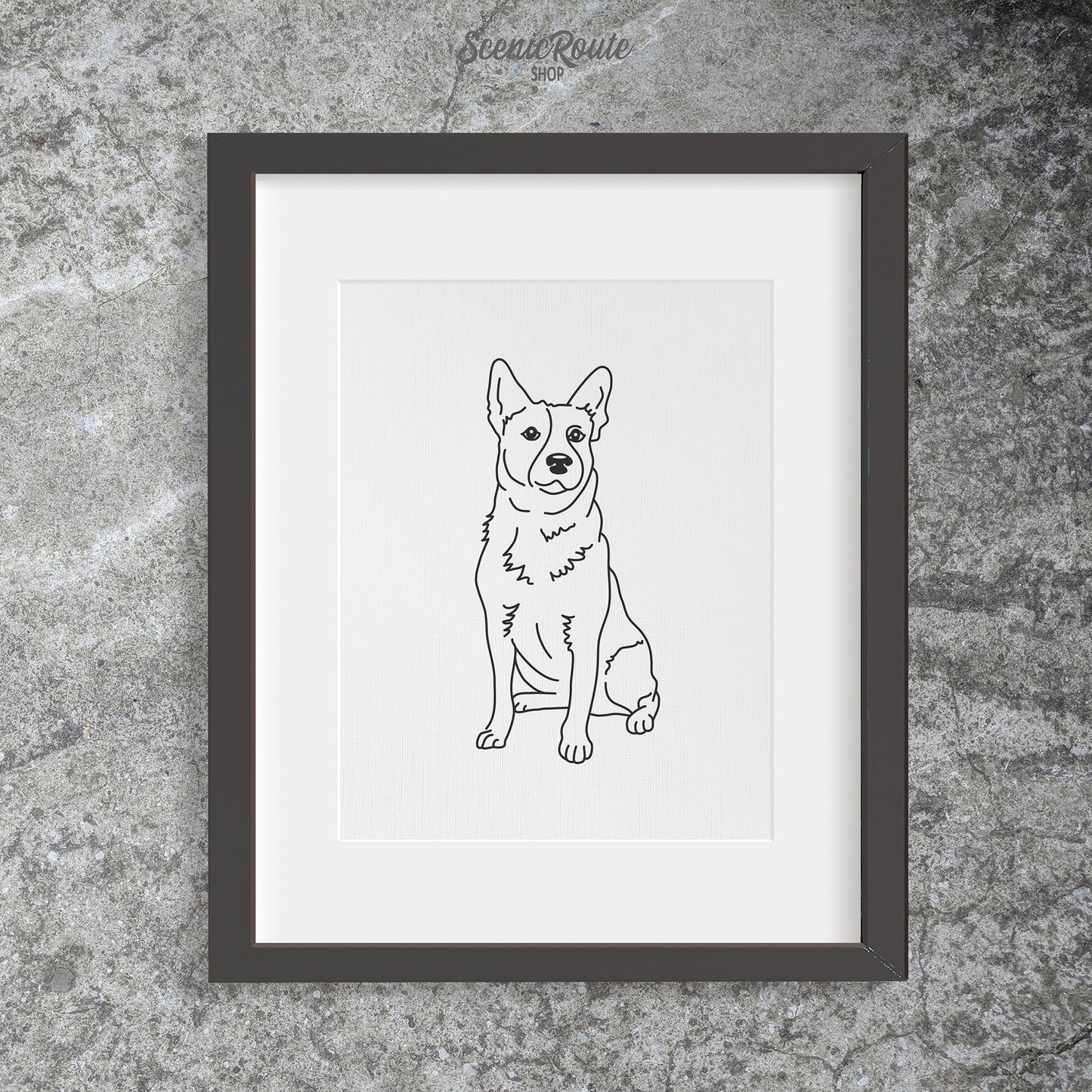 A drawing of an Australian Cattle Dog in a black frame on a concrete wall.