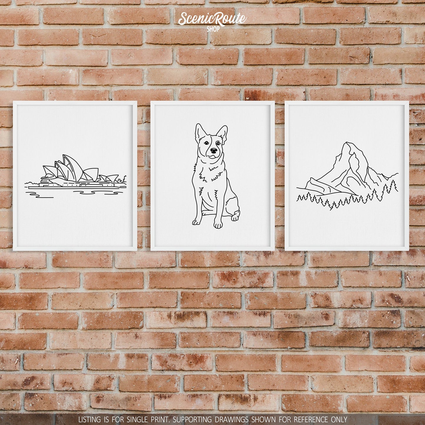 A group of three framed drawings on a brick wall.  The line art drawings include Sydney Opera House, Australian Cattle Dog, and Switzerland Matterhorn Mountain.