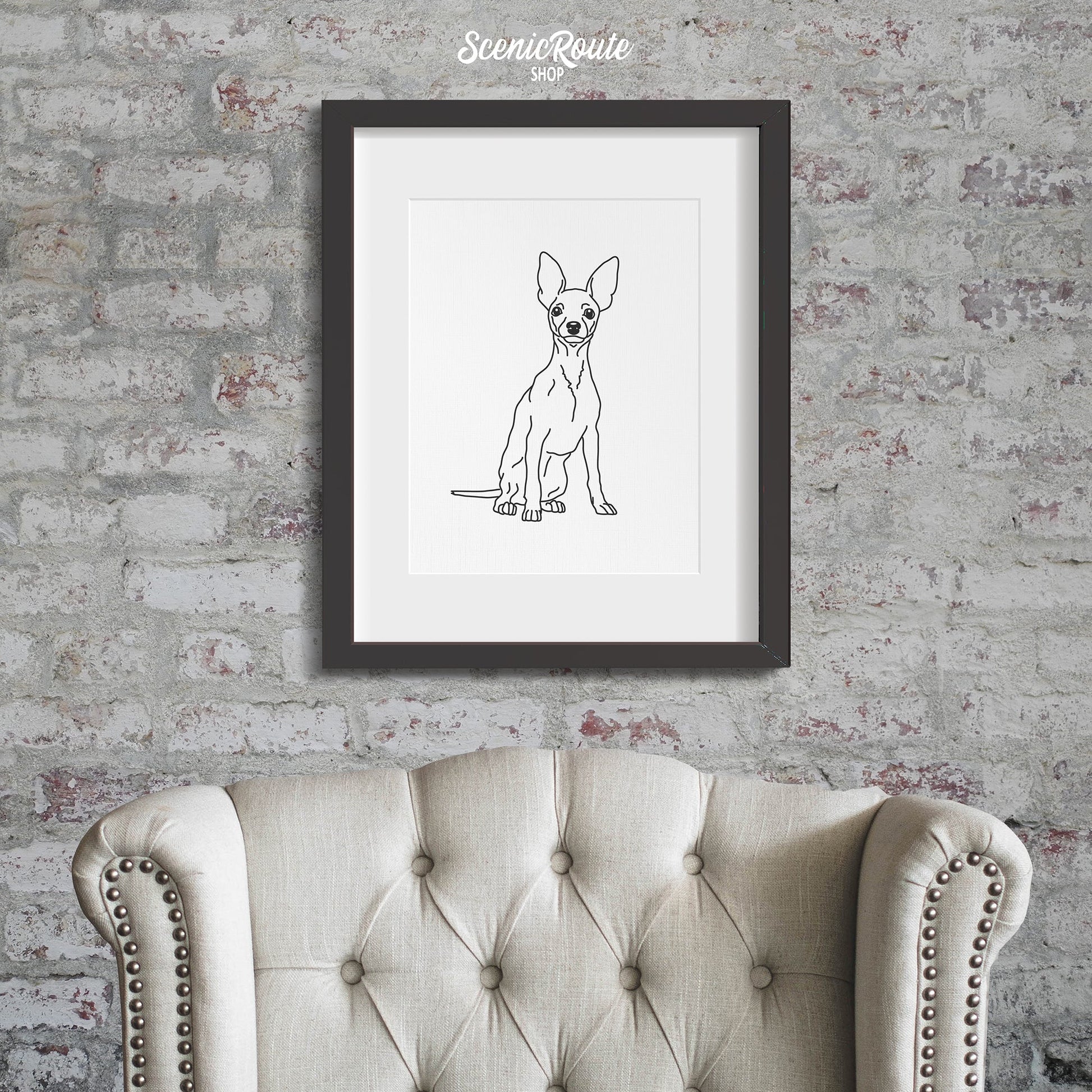 A framed line art drawing of a Miniature Pinscher dog on a brick wall above a chair