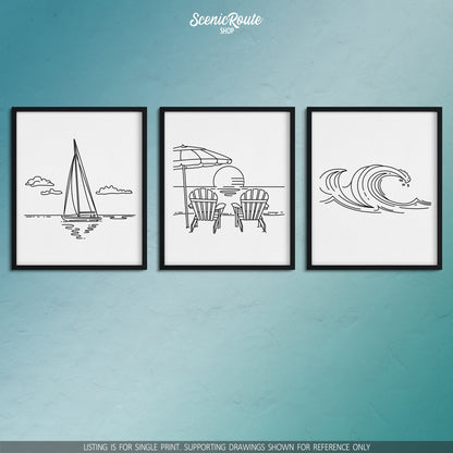 A group of three framed drawings on a blue wall. The line art drawings include Sailing, Adirondack Beach Chairs, and Waves