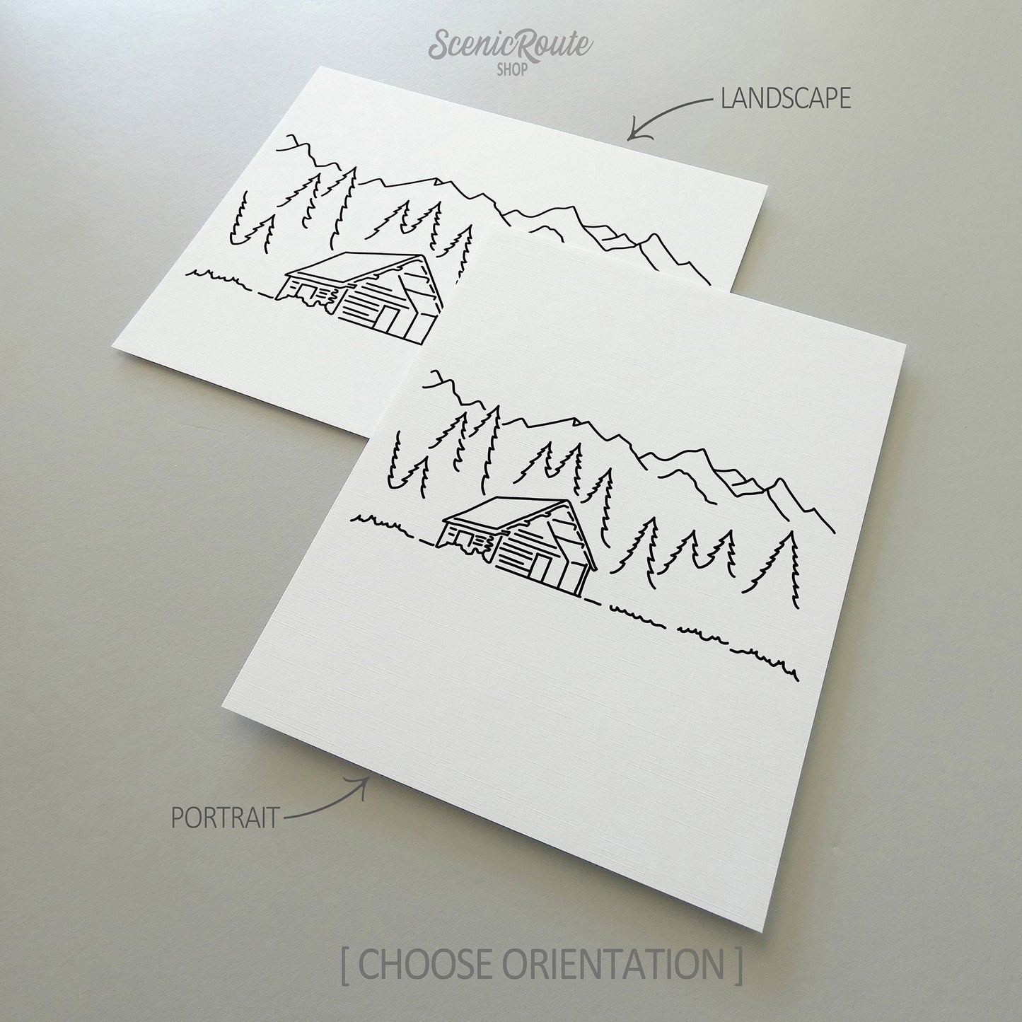 Two line art drawings of a Log Cabin on white linen paper with a gray background.  The pieces are shown in portrait and landscape orientation for the available art print options.