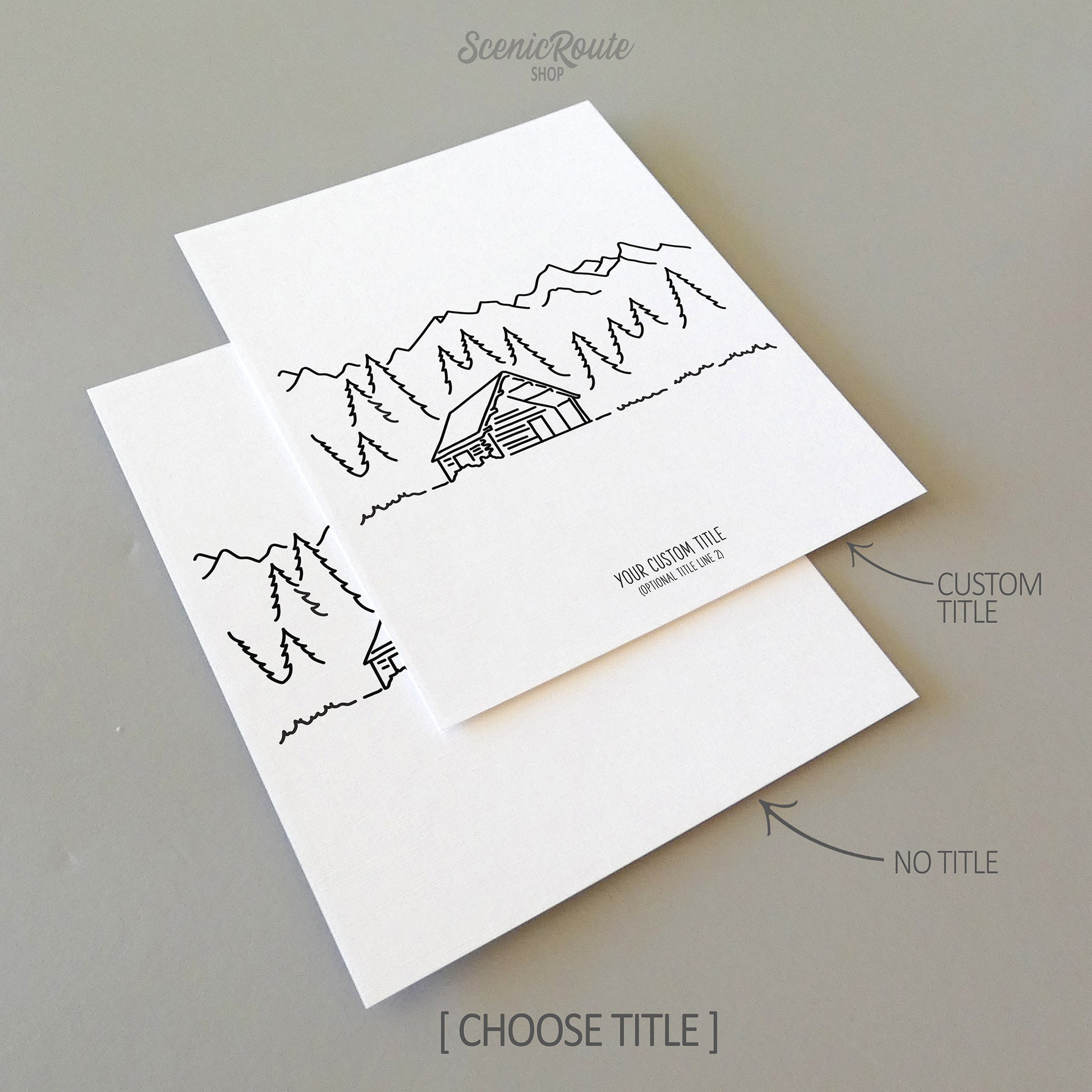 Two line art drawings of a cabin in the pine forest with mountains in the background on white linen paper with a gray background.  The pieces are shown with “No Title” and “Custom Title” options for the available art print options.