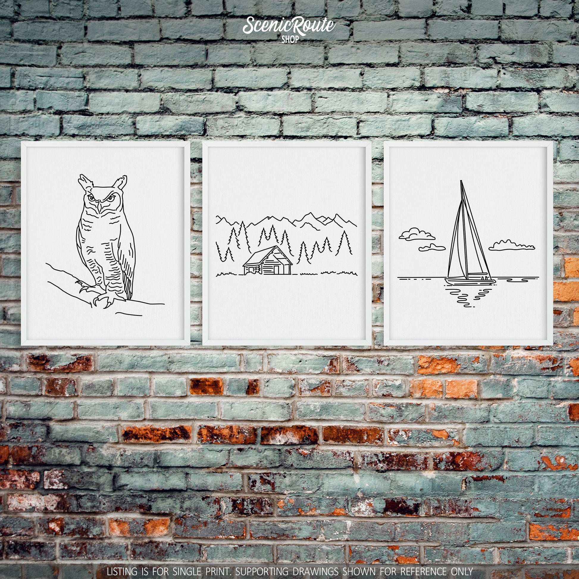 A group of three framed drawings on a brick wall. The line art drawings include an Owl, Log Cabin, and Sailing
