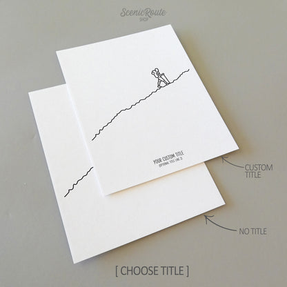 Two line art drawings of a hiker hiking up a mountain or hill on white linen paper with a gray background.  The pieces are shown with “No Title” and “Custom Title” options for the available art print options.