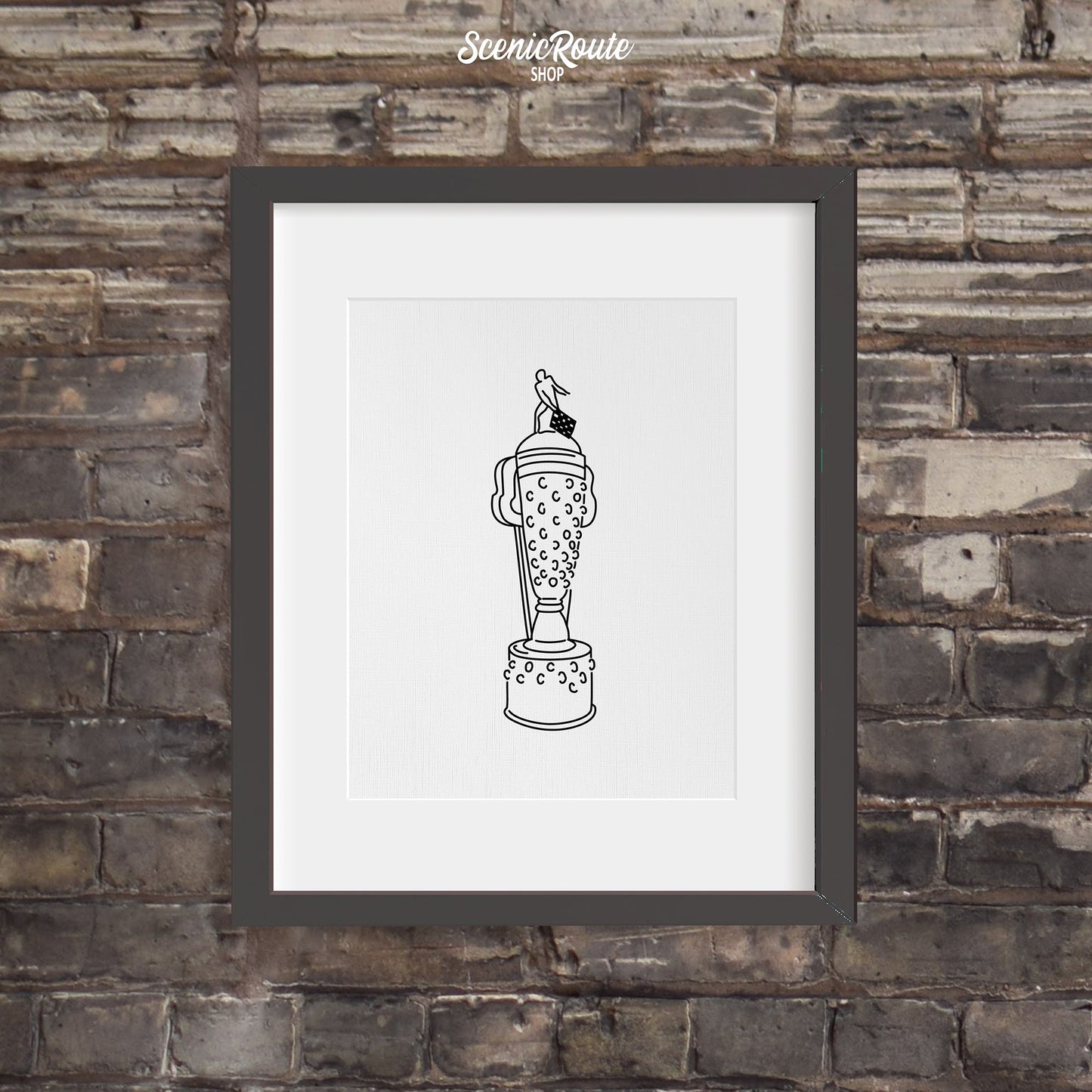 A framed line art drawing of the Indy Car Borg Warner Trophy on a brick wall