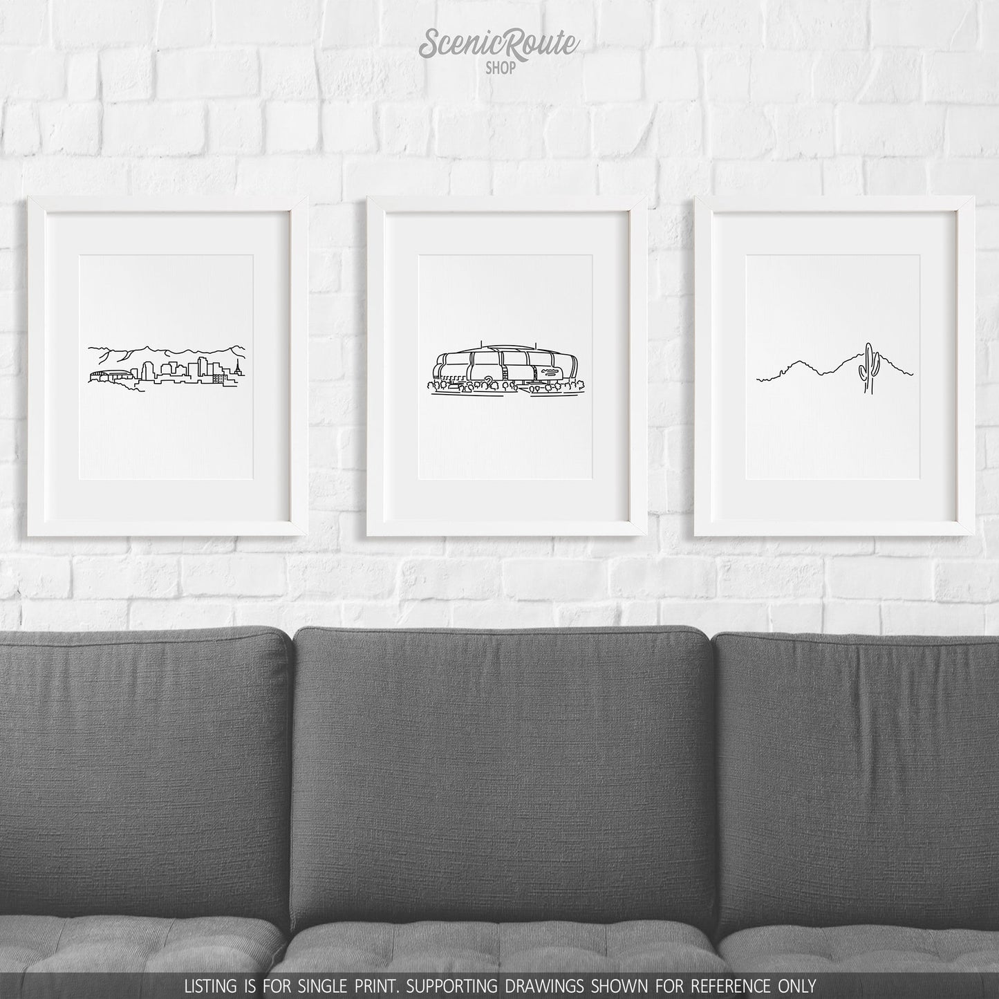 A group of three framed drawings on a wall above a couch. The line art drawings include the Phoenix Skyline, Cardinals Stadium, and Camelback Mountain