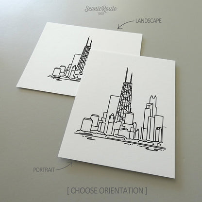 Two line art drawings of the John Hancock Tower on white linen paper with a gray background.  The pieces are shown in portrait and landscape orientation for the available art print options.