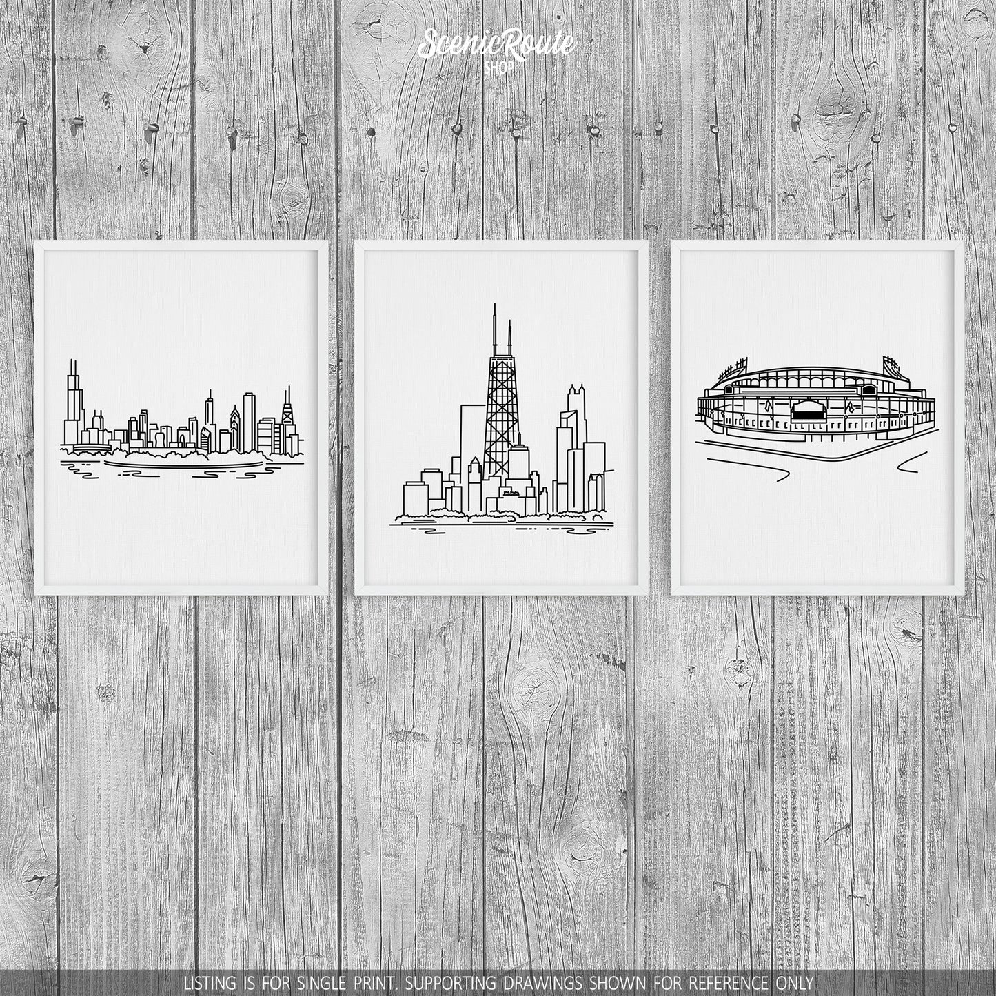 A group of three framed drawings on a wood wall. The line art drawings include the Chicago Skyline, John Hancock Tower, and Wrigley Field