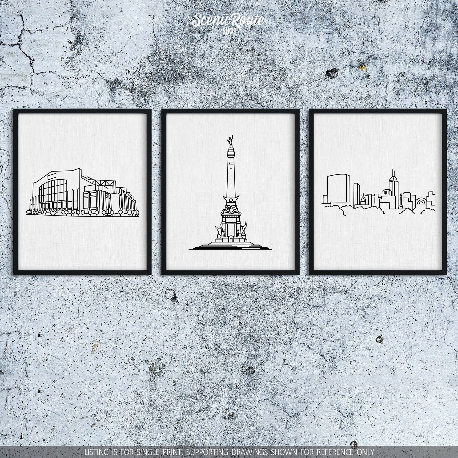 A group of three framed drawings on a concrete wall. The line art drawings include the Colts Stadium, Soldiers and Sailors Monument, and Indianapolis Skyline