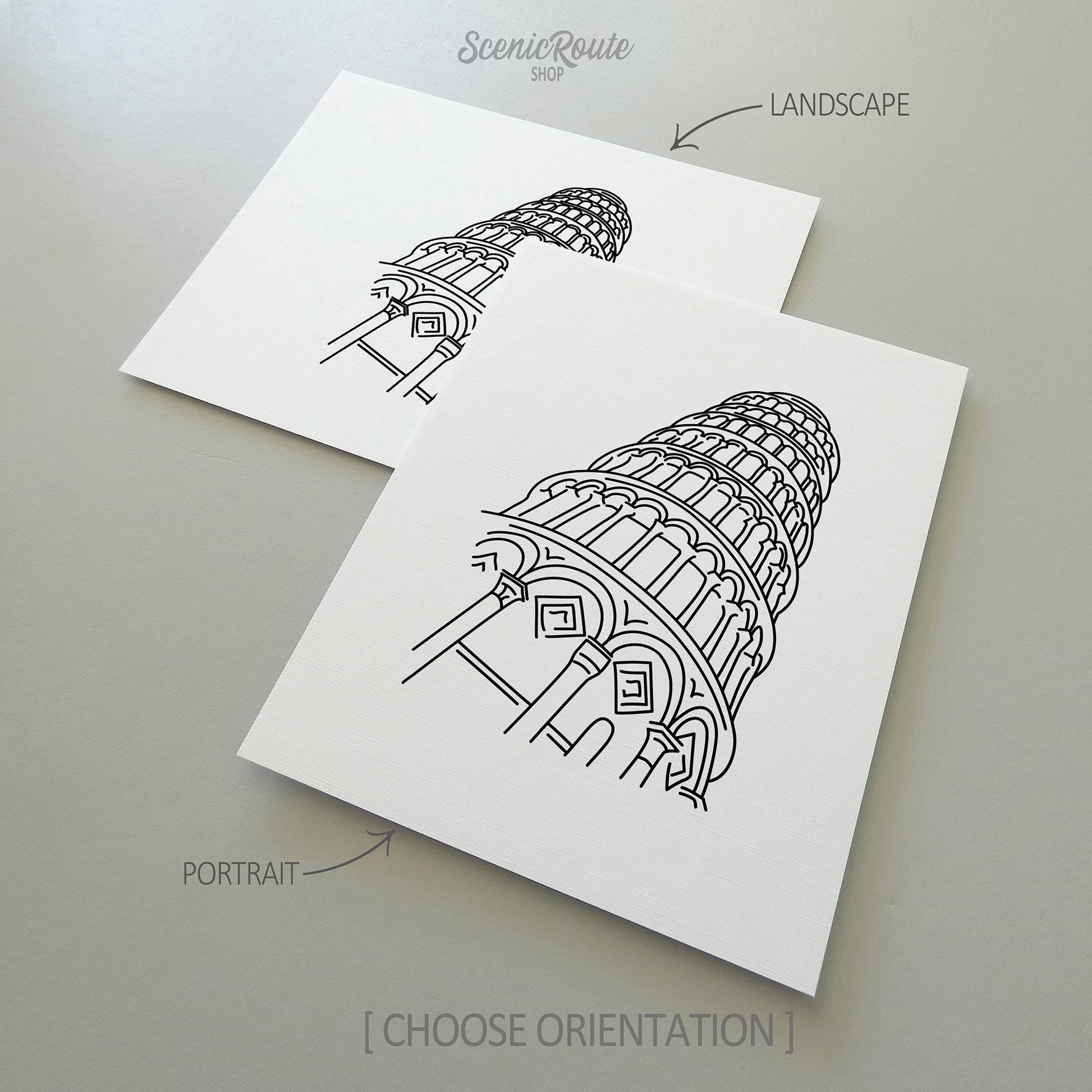 Two line art drawings of the Leaning Tower of Pisa on white linen paper with a gray background.  The pieces are shown in portrait and landscape orientation for the available art print options.