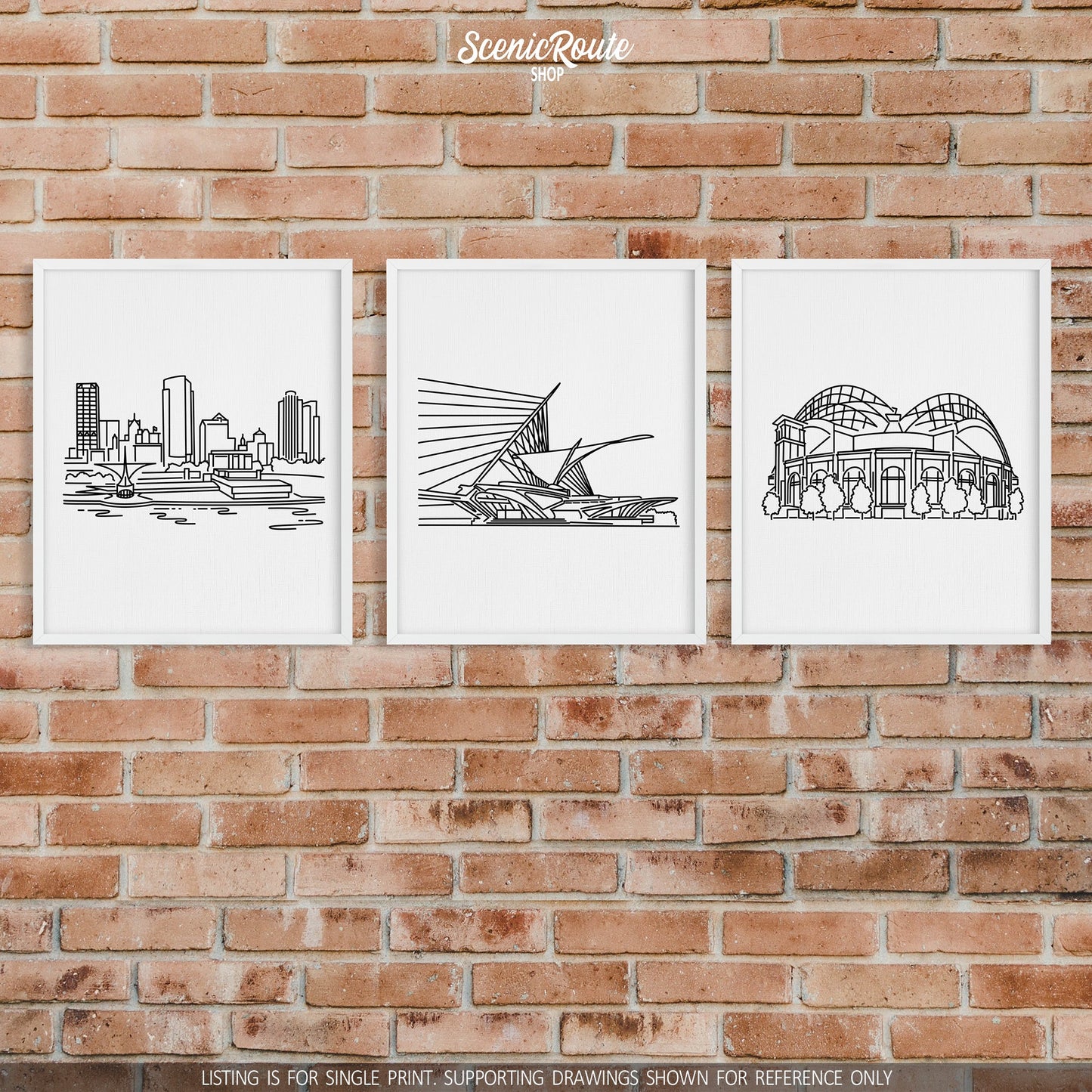 A group of three framed drawings on a brick wall. The line art drawings include the Milwaukee Skyline, Milwaukee Art Museum, and the Brewers Stadium