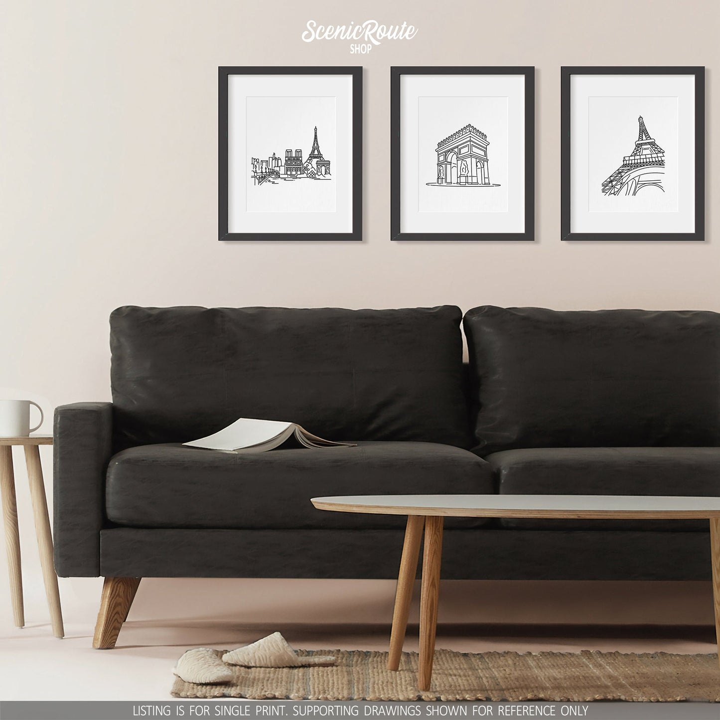A group of three framed drawings on a wall above a couch. The line art drawings include the Paris Skyline, Arc de Triomphe, and Eiffel Tower