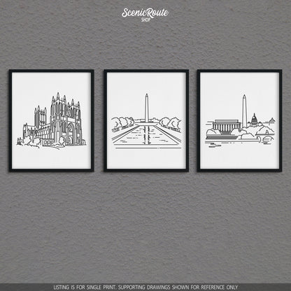 A group of three framed drawings on a gray wall. The line art drawings include the National Cathedral, National Mall, and Washington DC Skyline
