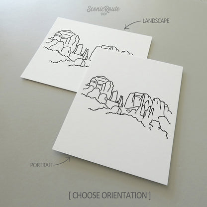 Two line art drawings of Sedona Cathedral Rock on white linen paper with a gray background.  The pieces are shown in portrait and landscape orientation for the available art print options.