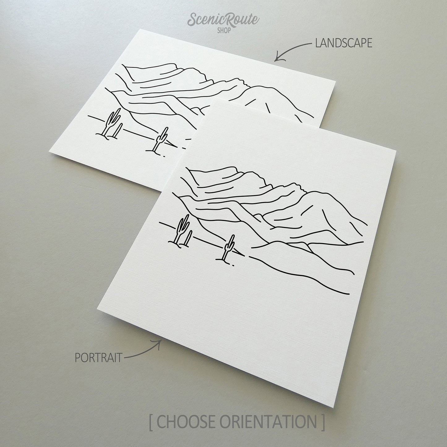 Two line art drawings of Four Peaks Mountains on white linen paper with a gray background.  The pieces are shown in portrait and landscape orientation for the available art print options.