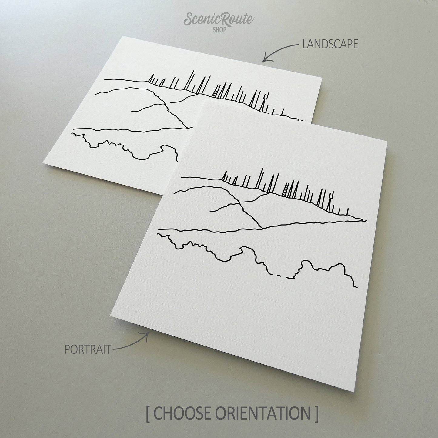 Two line art drawings of Phoenix South Mountain on white linen paper with a gray background. The pieces are shown in portrait and landscape orientation for the available art print options.