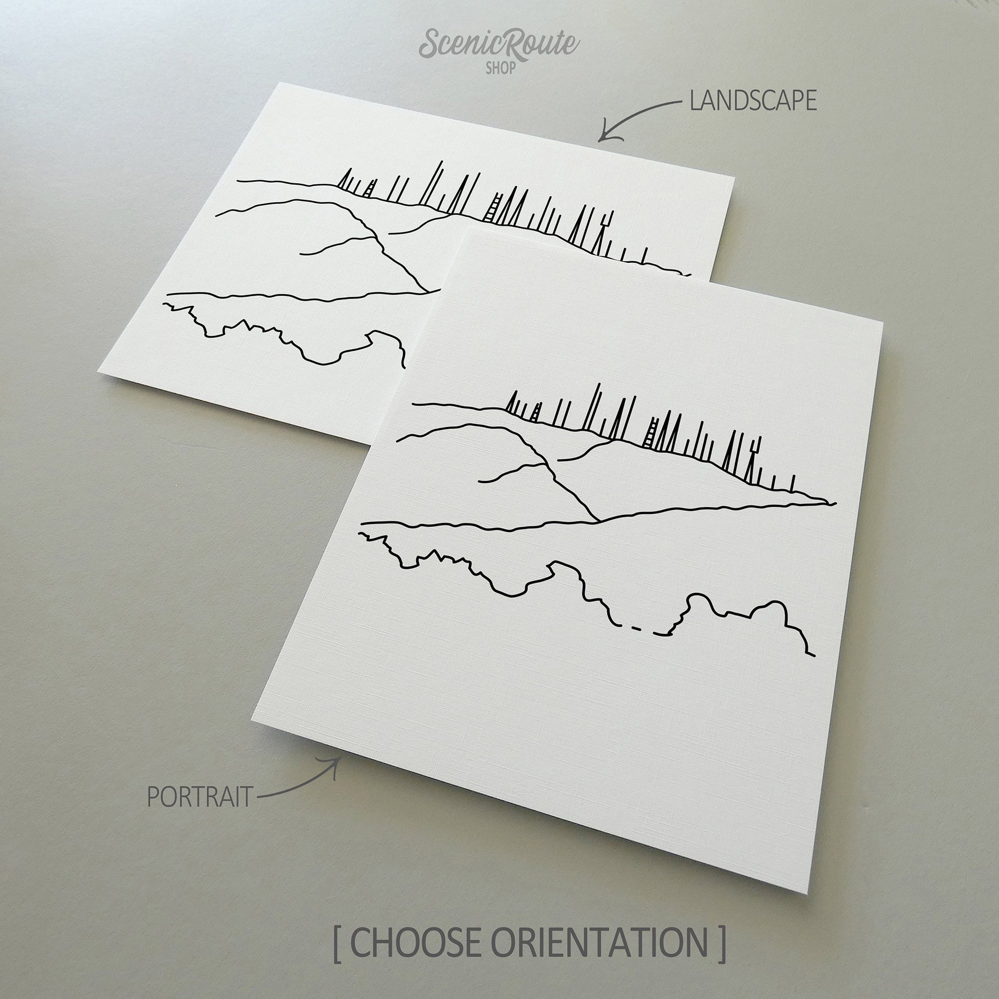 Two line art drawings of Phoenix South Mountain on white linen paper with a gray background.  The pieces are shown in portrait and landscape orientation for the available art print options.