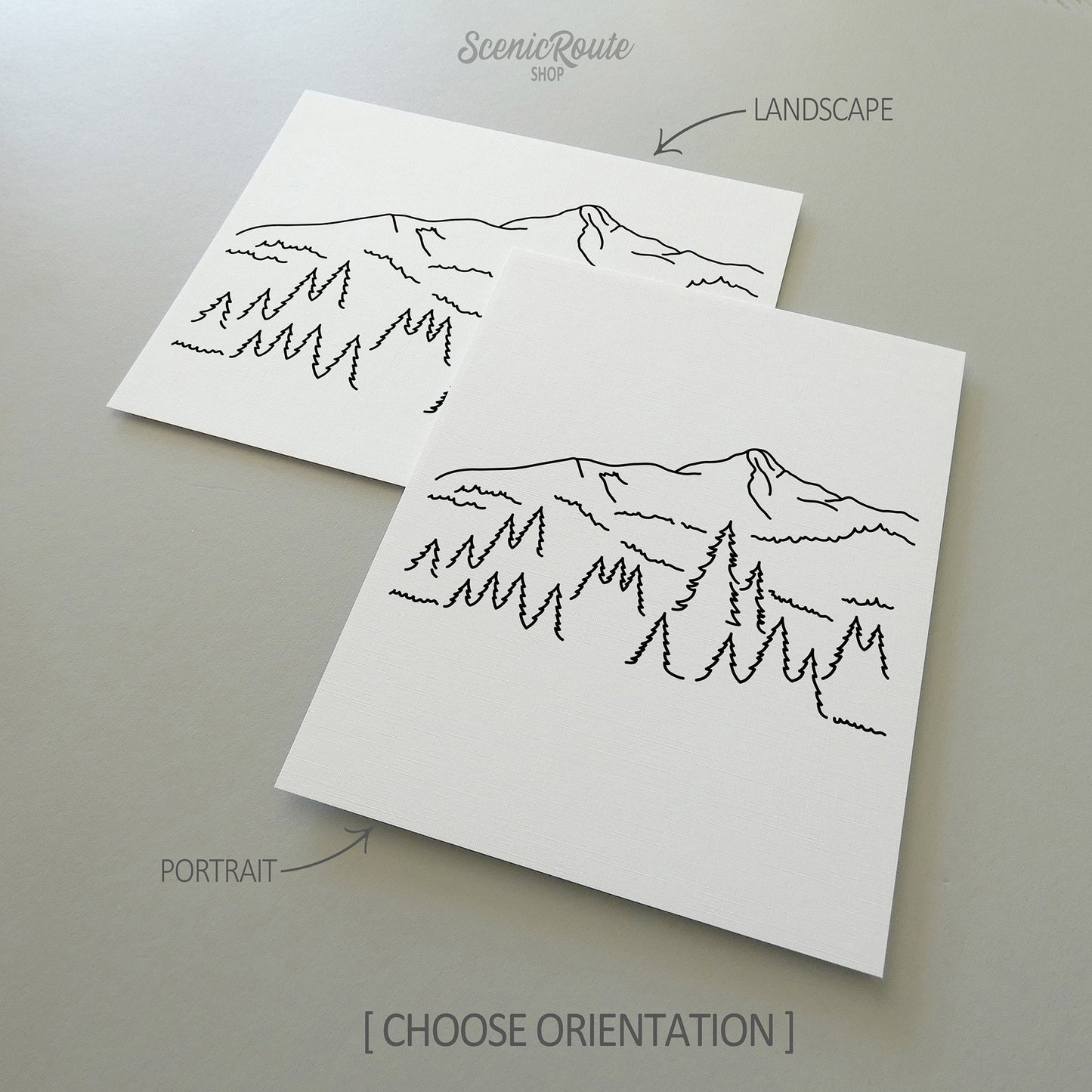 Two line art drawings of Big Sky Montana on white linen paper with a gray background.  The pieces are shown in portrait and landscape orientation for the available art print options.