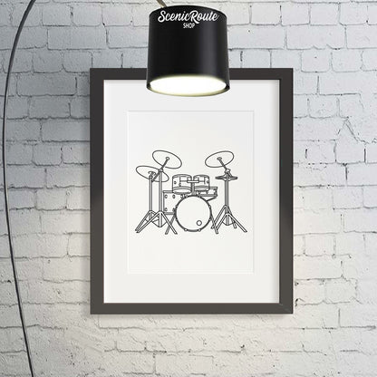 A framed line art drawing of Drums with a large lamp