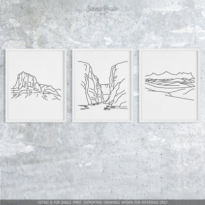 A group of three framed drawings on a concrete wall. The line art drawings include Guadalupe National Park, Big Bend National Park, and White Sands National Park