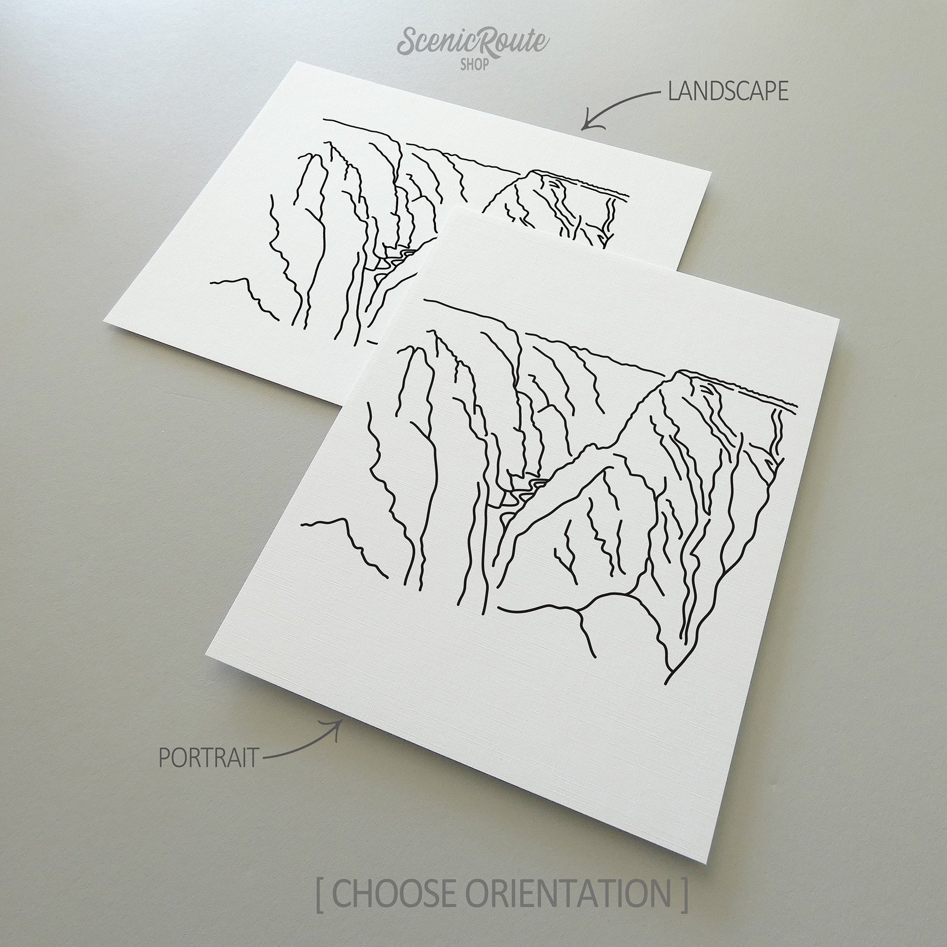 Two line art drawings of Black Canyon of the Gunnison National Park on white linen paper with a gray background.  The pieces are shown in portrait and landscape orientation for the available art print options.