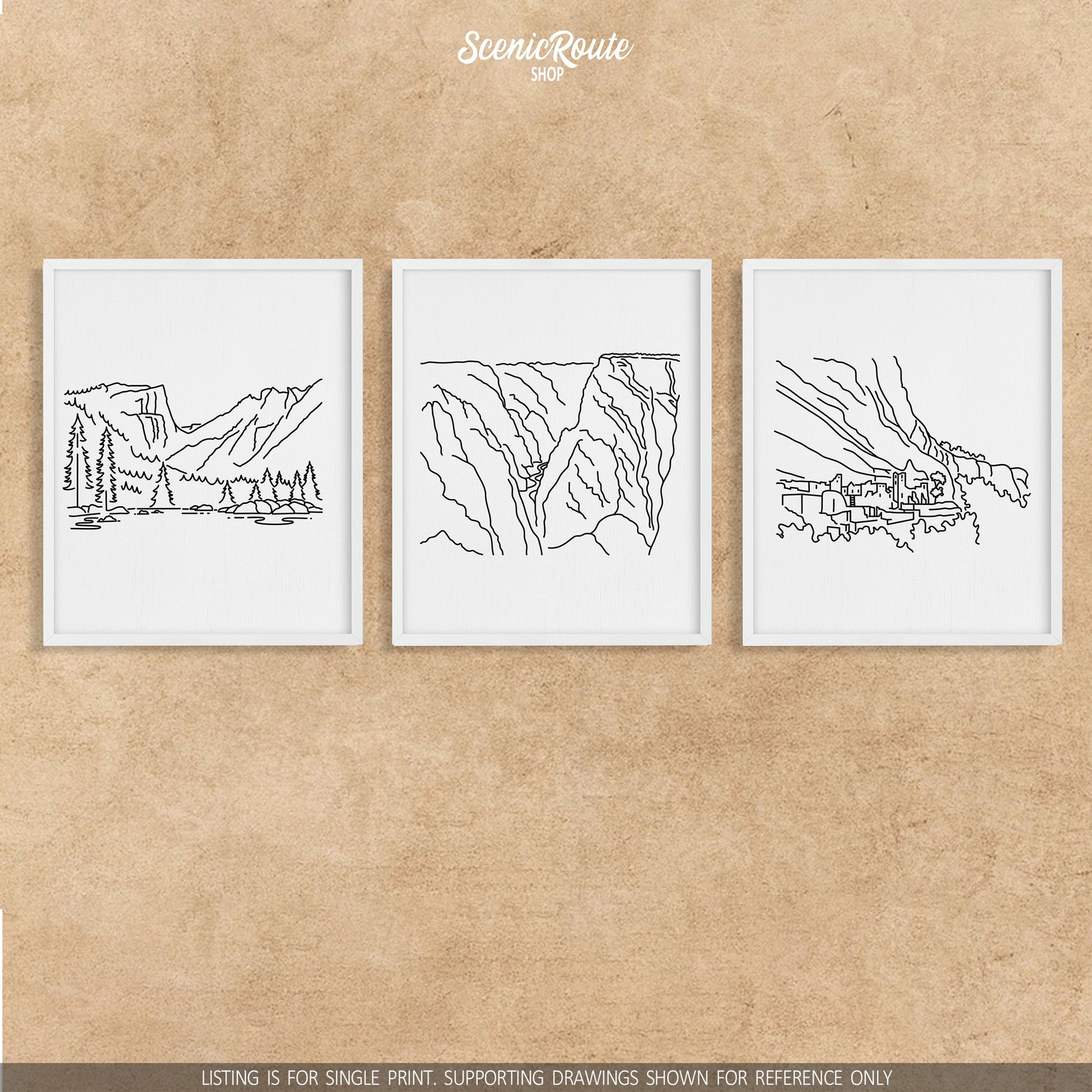 A group of three framed drawings on a wall. The line art drawings include Rocky Mountain National Park, Black Canyon of the Gunnison National Park, and Mesa Verde National Park