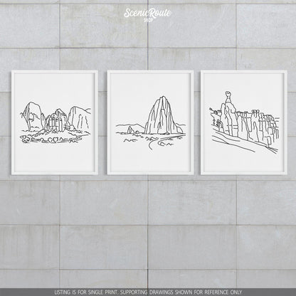 A group of three framed drawings on a block wall. The line art drawings include Zion National Park, Capitol Reef National Park, and Bryce Canyon National Park
