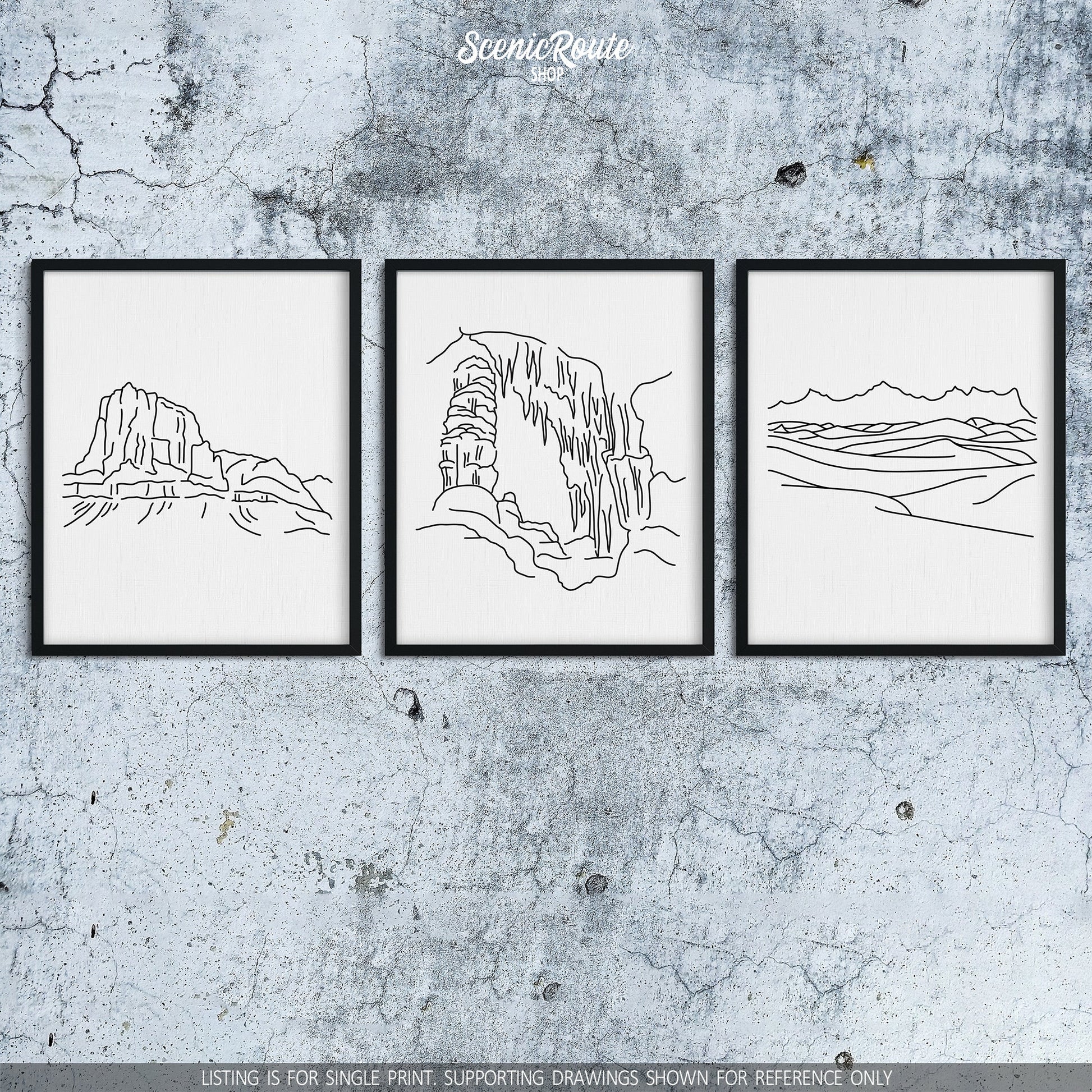 A group of three framed drawings on a concrete wall. The line art drawings include Guadalupe Mountains National Park, Carlsbad Caverns National Park, and White Sands National Park