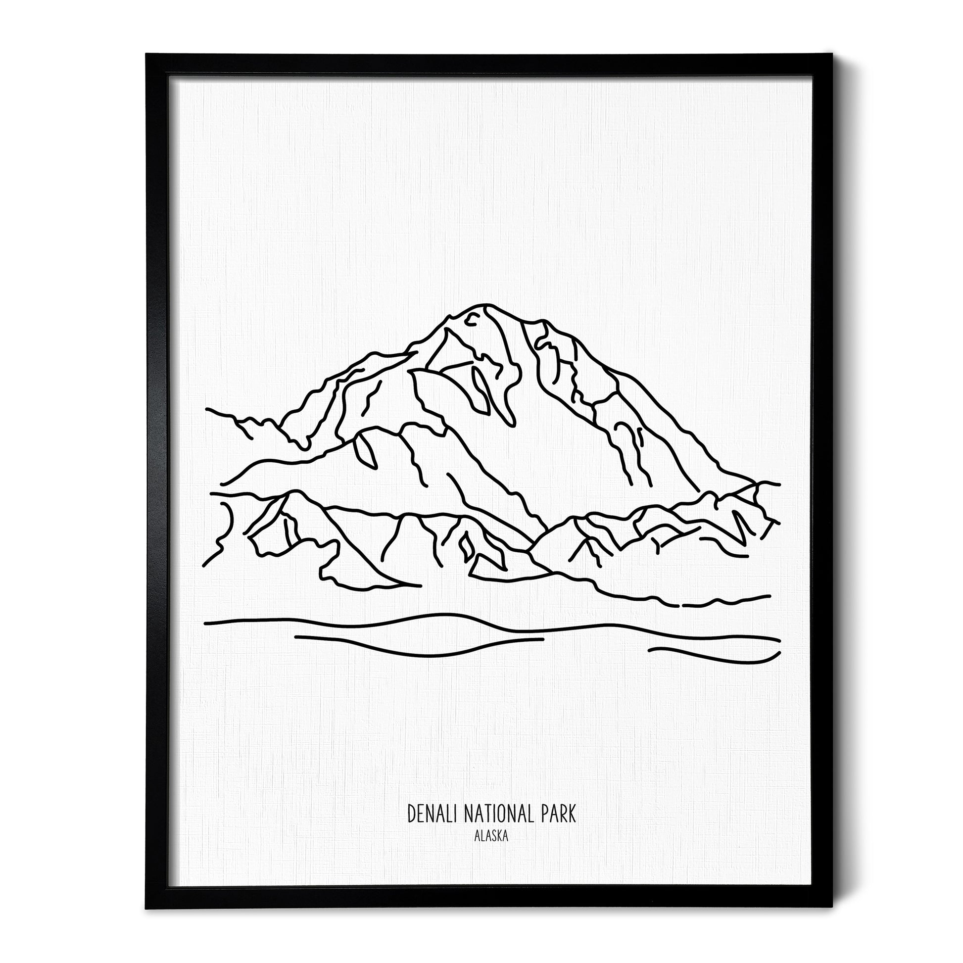 A line art drawing of Denali National Park on white linen paper in a thin black picture frame