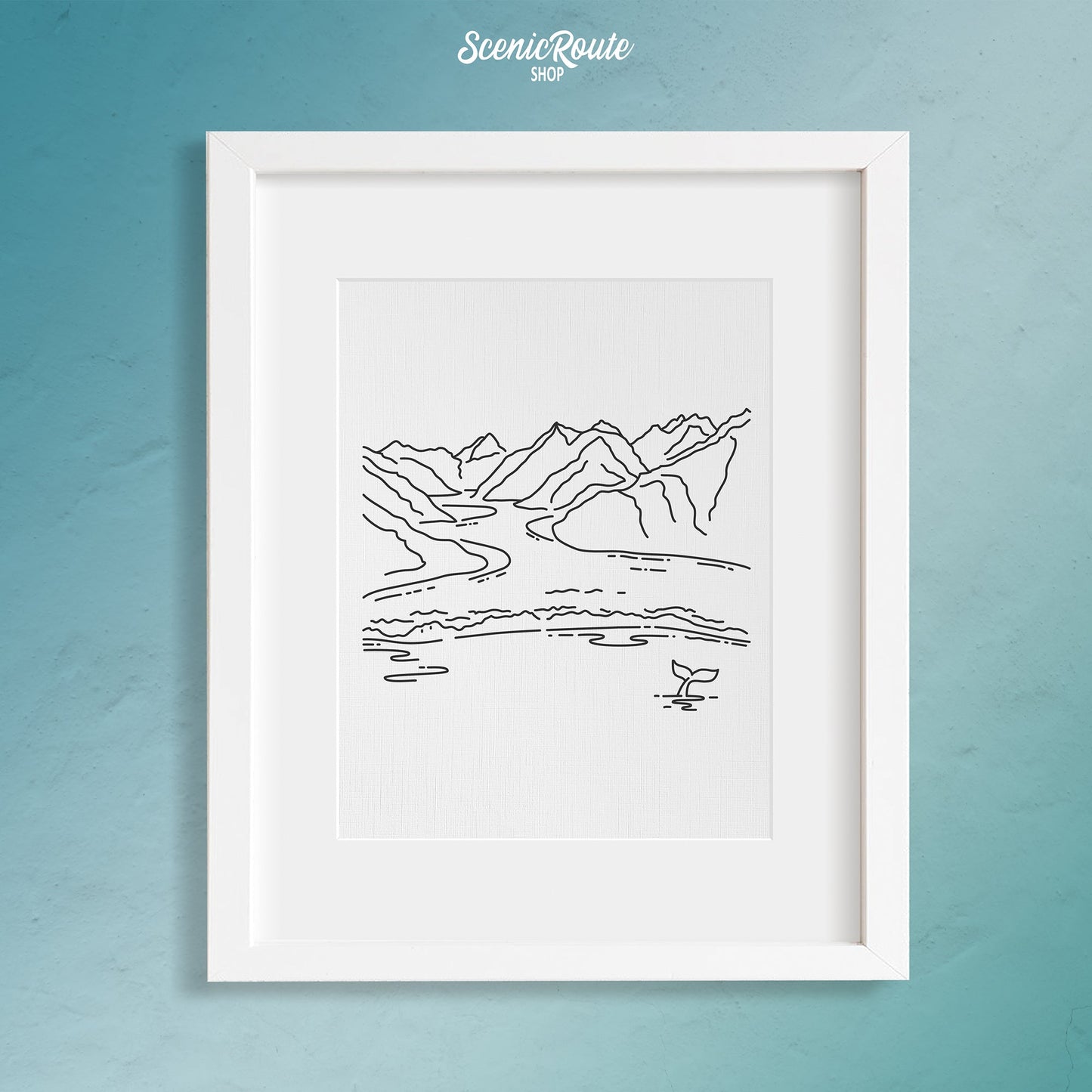 A framed line art drawing of Glacier Bay National Park on a blue wall