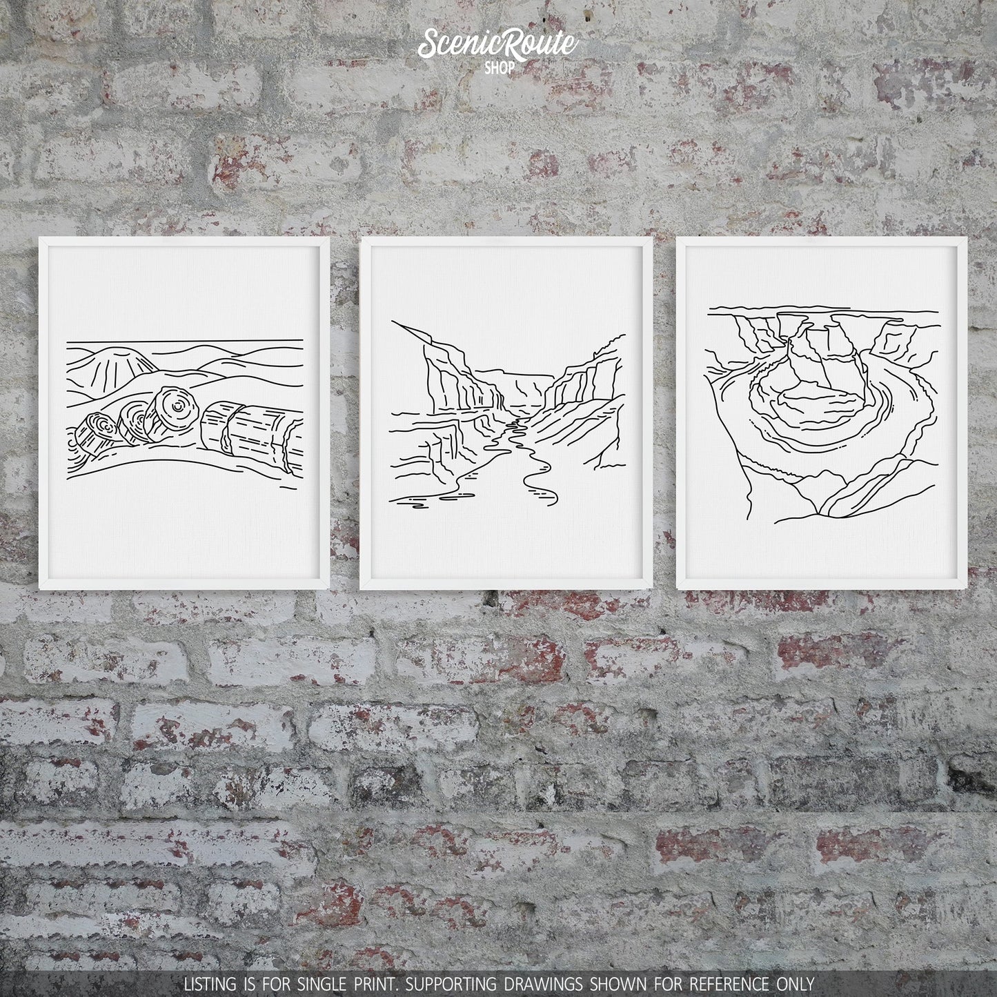A group of three framed drawings on a brick wall. The line art drawings include Petrified Forest National Park, Grand Canyon National Park, and Horseshoe Bend