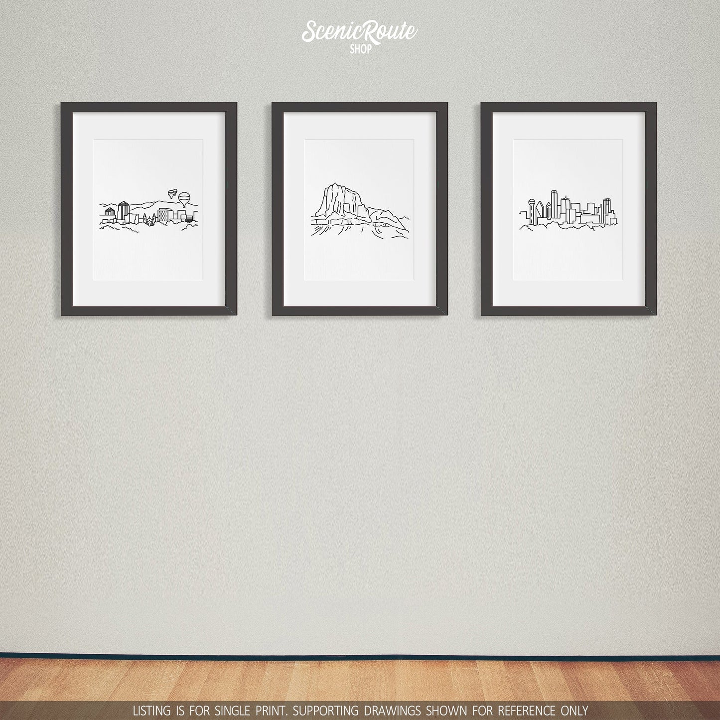 A group of three framed drawings on a white wall. The line art drawings include the Albuquerque Skyline, Guadalupe National Park, and the Dallas Skyline