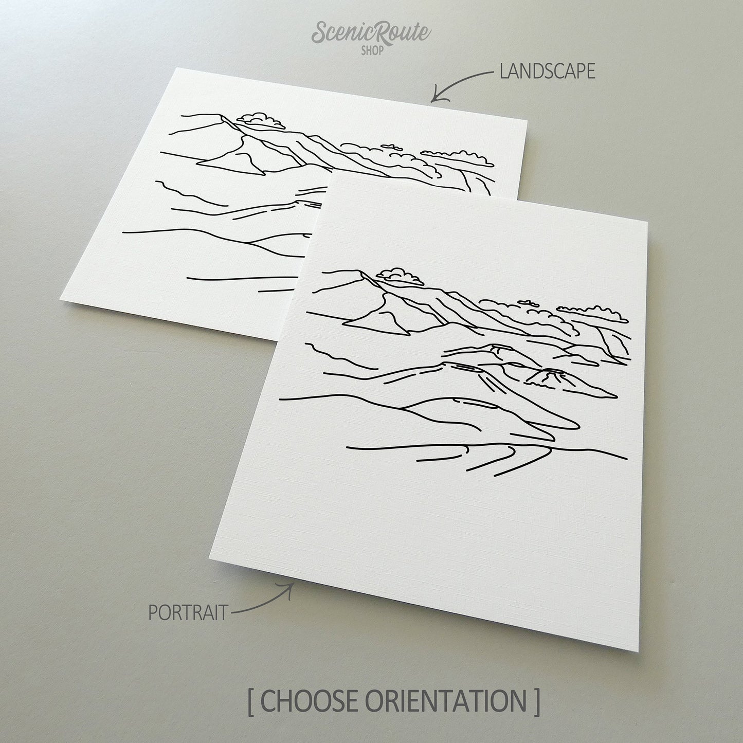 Two line art drawings of Haleakala National Park on white linen paper with a gray background. The pieces are shown in portrait and landscape orientation for the available art print options.