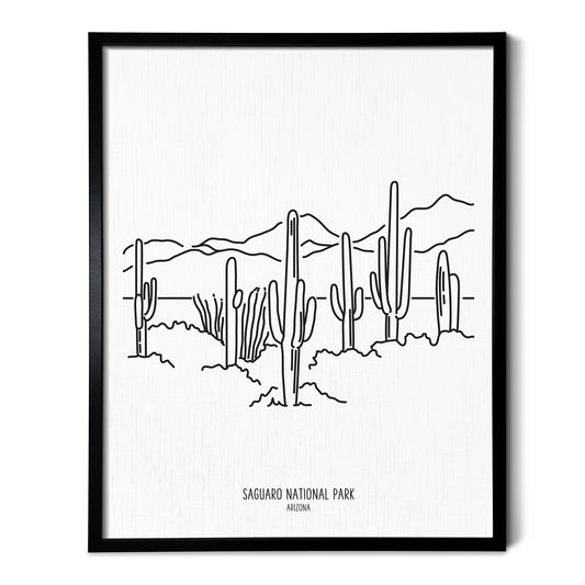 A line art drawing of Saguaro National Park on white linen paper in a thin black picture frame