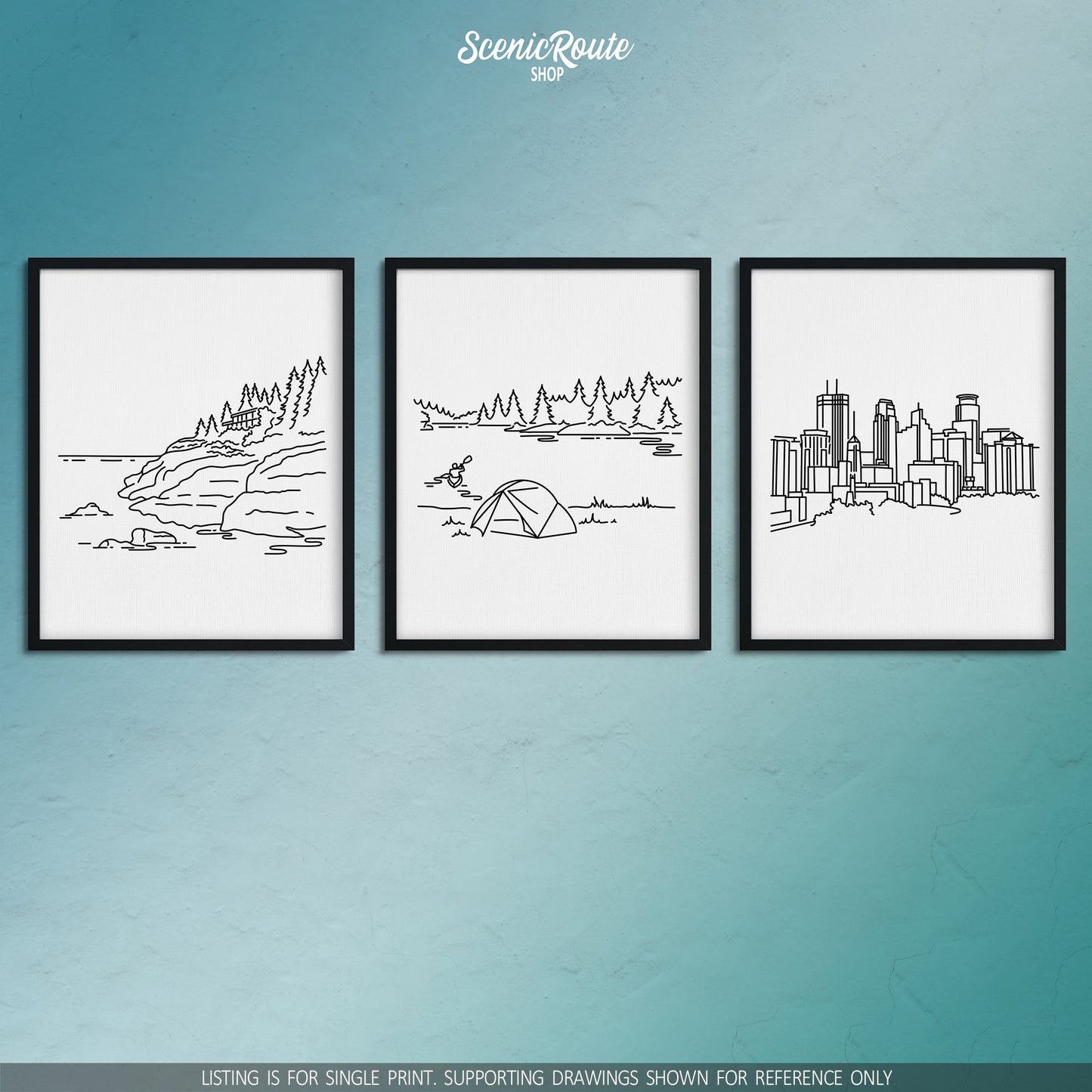 A group of three framed drawings on a blue wall. The line art drawings include Isle Royale National Park, Voyageurs National Park, and the Minneapolis Skyline