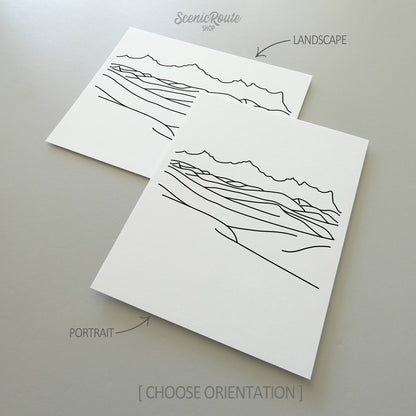 Two line art drawings of White Sands National Park on white linen paper with a gray background.  The pieces are shown in portrait and landscape orientation for the available art print options.