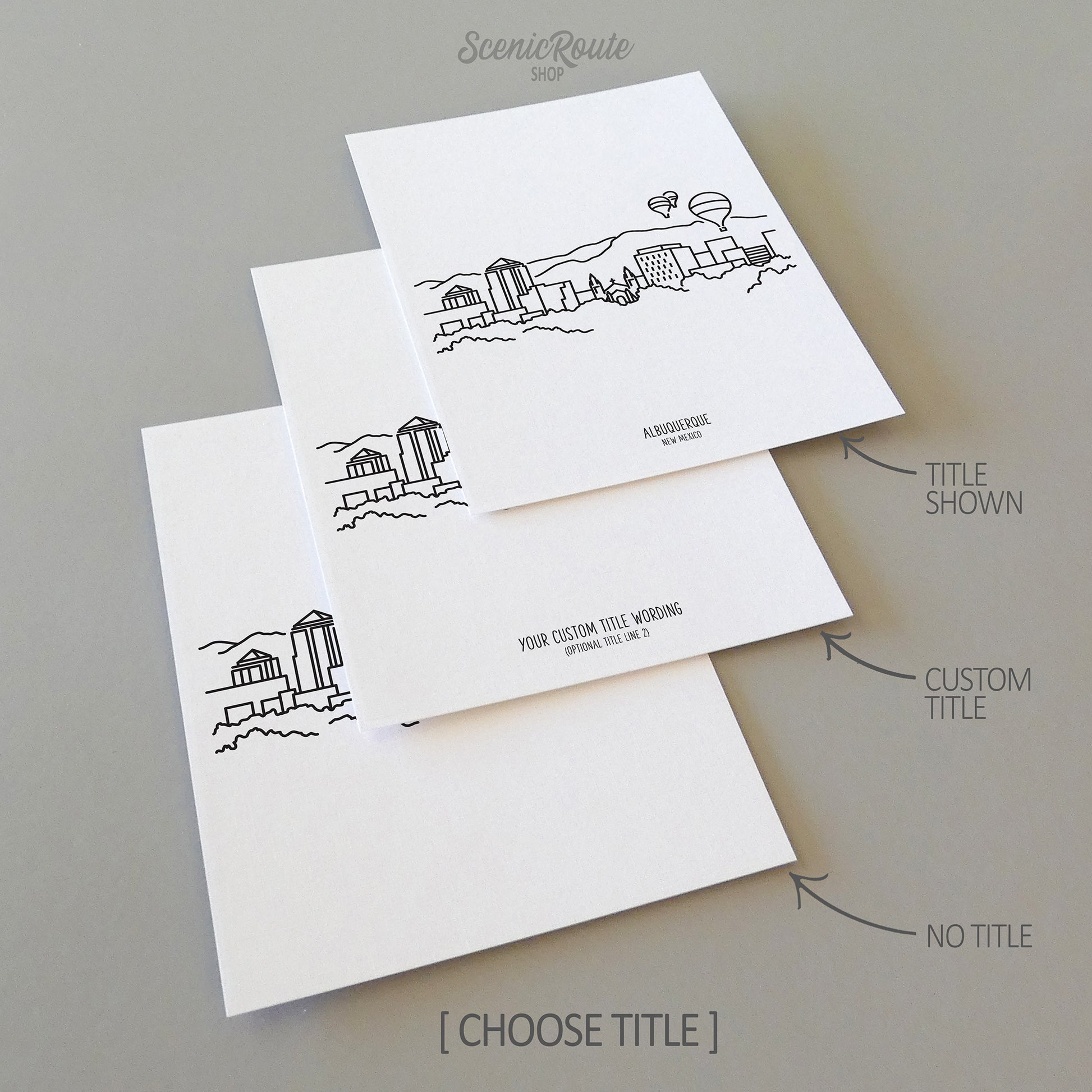 Three line art drawings of the Albuquerque New Mexico Skyline on white linen paper with a gray background. The pieces are shown with title options that can be chosen and personalized.