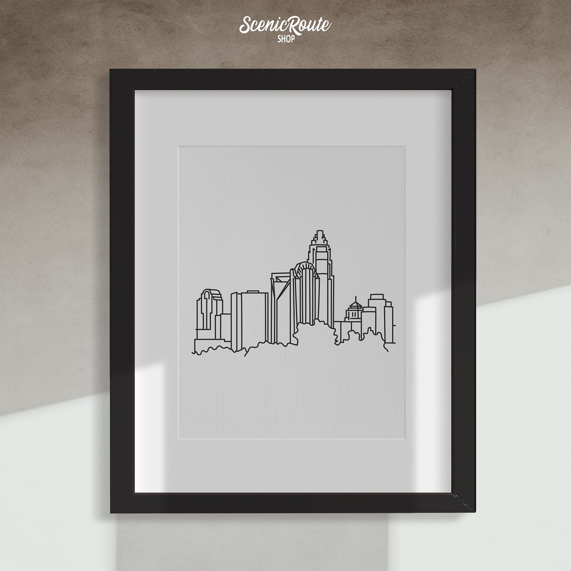 A framed line art drawing of the Charlotte Skyline