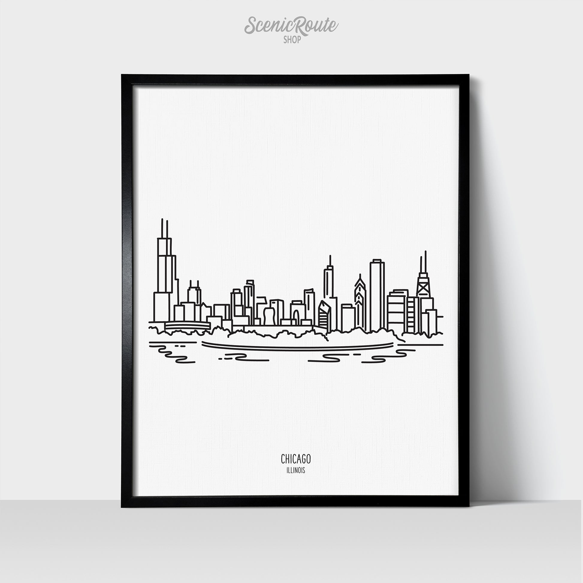 A line art drawing of the Chicago Illinois Skyline on white linen paper in a thin black picture frame